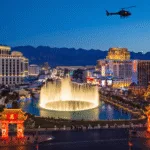 "Winter night cityscape of Las Vegas Strip with Bellagio fountains, Lunar New Year decorations, tourists, a helicopter tour and Red Rock Canyon in the background, under a 60°F clear sky."